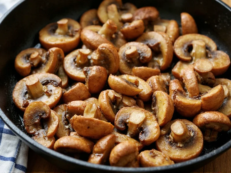 Golden brown mushrooms sizzling in cast iron skillet