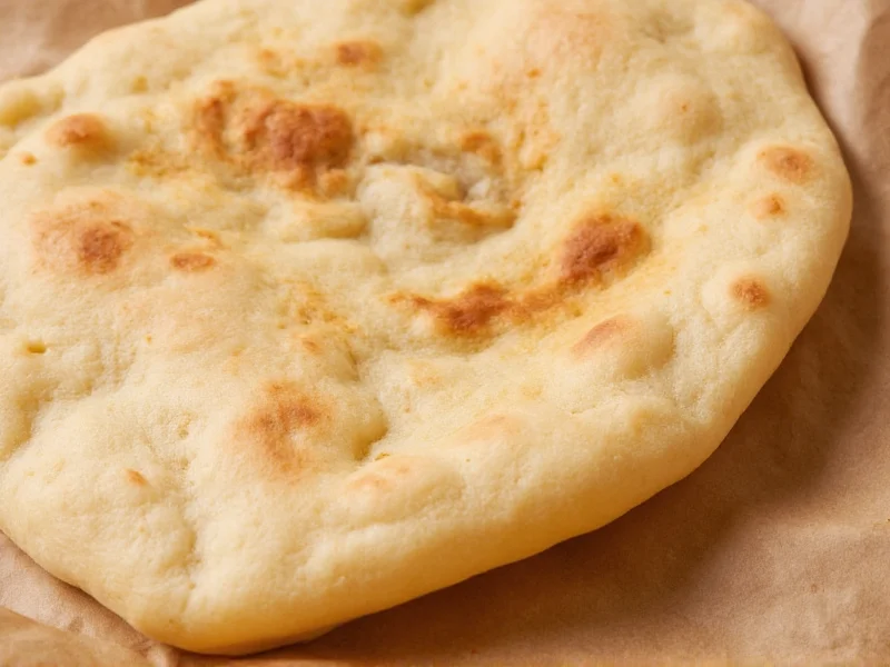 Freshly baked pita bread with visible steam pocket