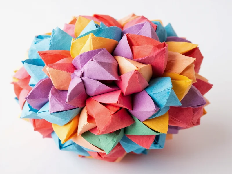 Hand assembling geometric paper kusudama ball