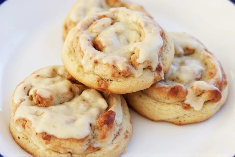 Perfectly swirled cinnamon roll cookies on a baking sheet with golden edges and soft centers