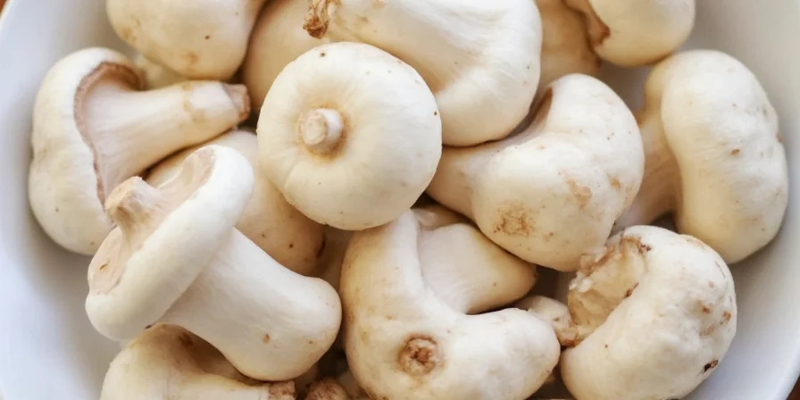 Cooking white mushrooms on a pan