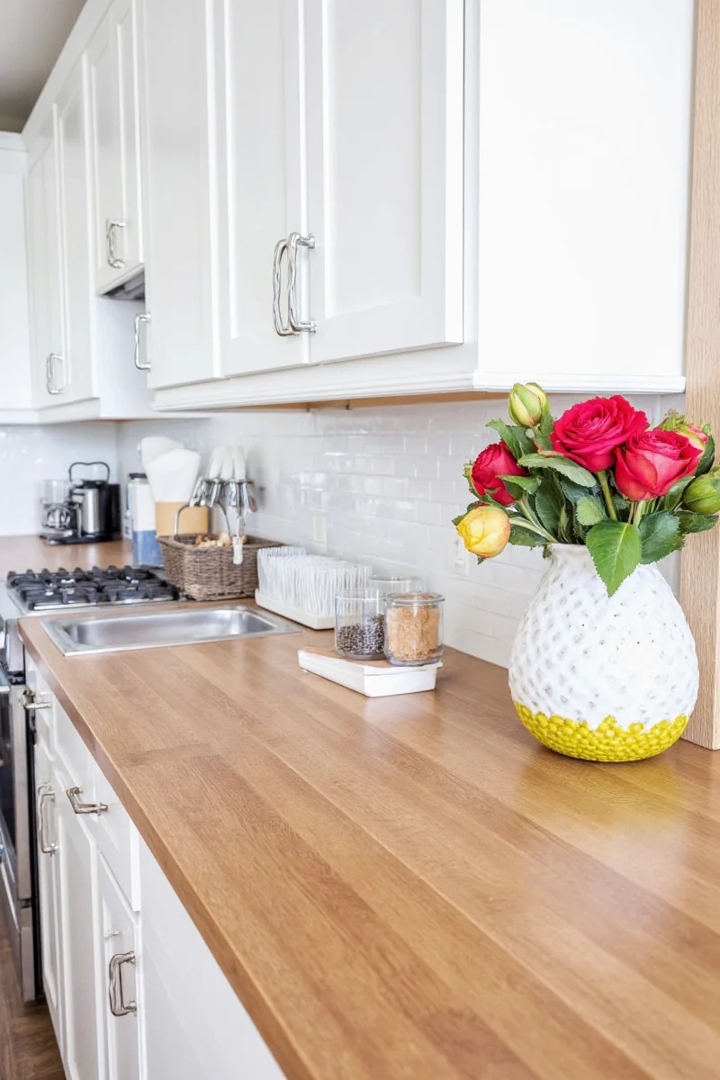 Kitchen with wood countertop and stylish backsplash