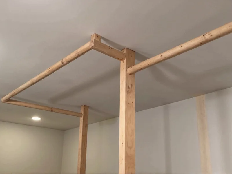 Completed DIY dip bar installed in home gym space