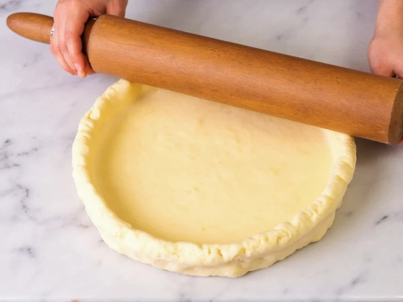Rolled pie crust being transferred to pie dish using rolling pin