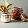 Speckled earthenware flower pot with rattan