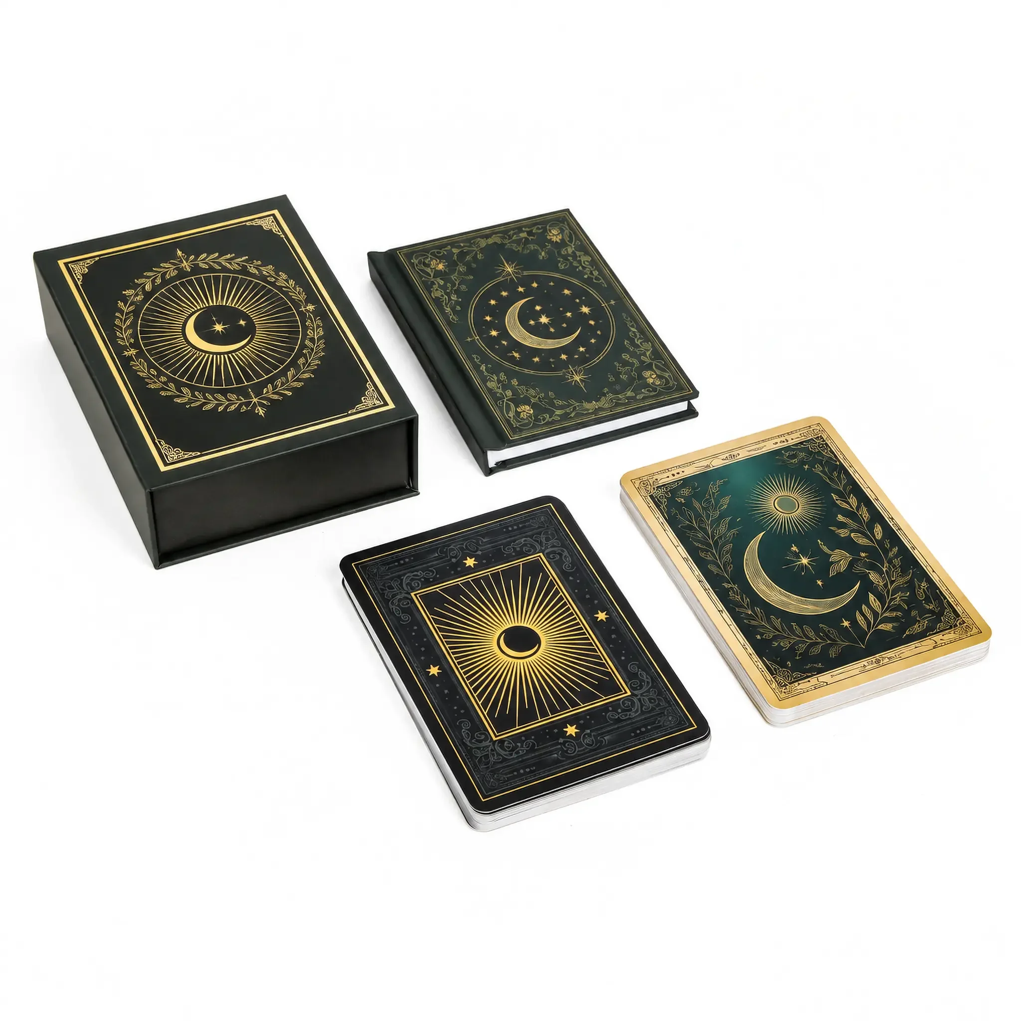 Closed custom tarot box with a gold foil circular frame beside a matching foil stamped guidebook and the deck