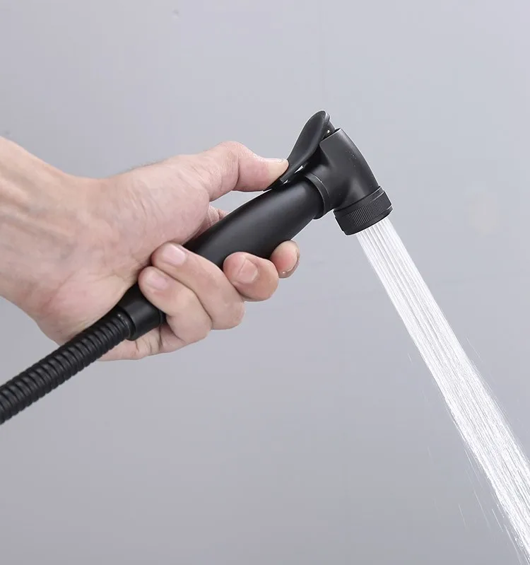 product-1-1 wall-mounted-bidet-sprayer-055d-matte-black-water-stream-in-hand-close-up-use