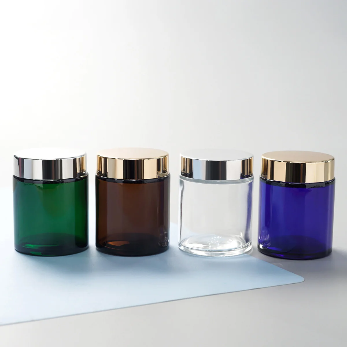 

100g cosmetic mini glass jar containers with lid Customized colored and round shape