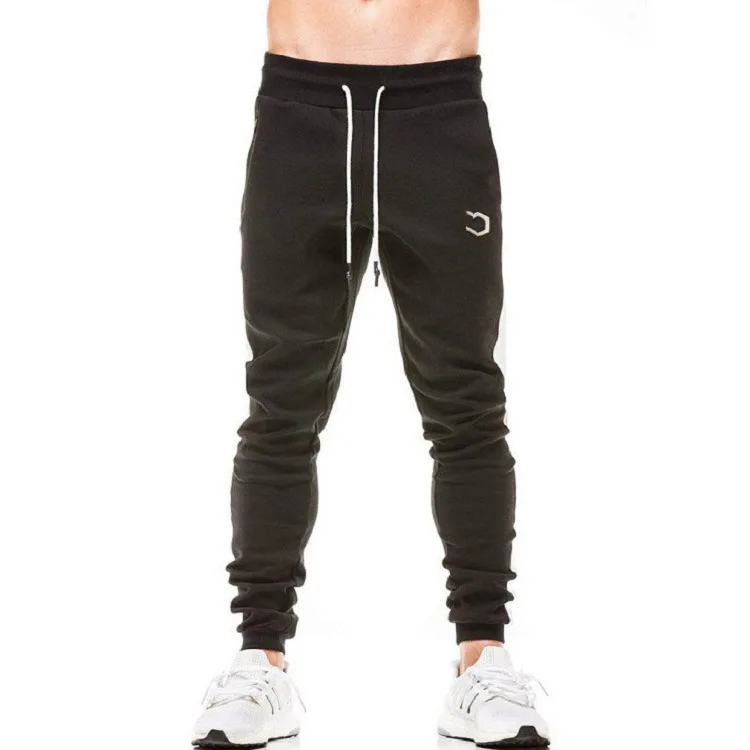Тренировочные штаны мужские. Брюки тренировочные для бодибилдинга. Мужские спортивные штаны черные с белой полоской under Armour. Брюки спортивные adidas own the Run Colorblock Joggers. Black man Sweatpants.