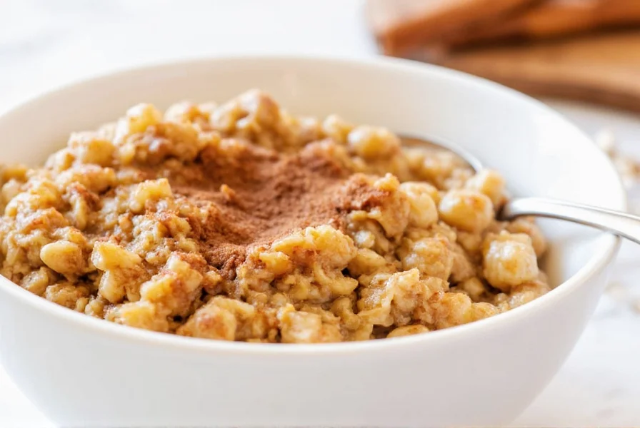 Close-up of steaming cinnamon oatmeal in a white bowl with cinnamon stick and fresh berries