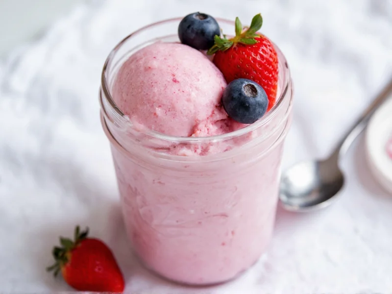 Homemade dairy free ice cream in mason jar with fresh berries