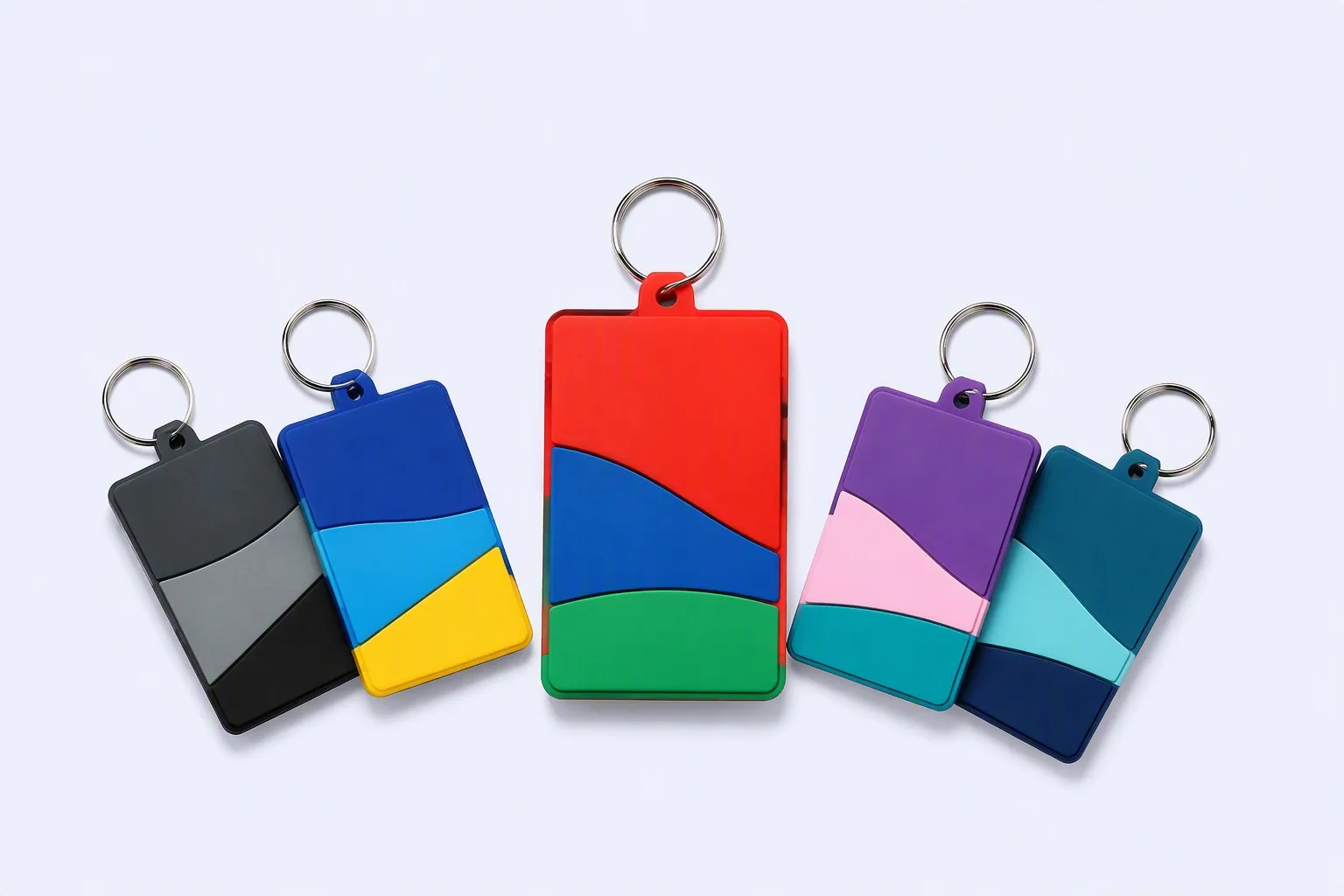 Colorful custom PVC rubber keychain tags in a fan arrangement