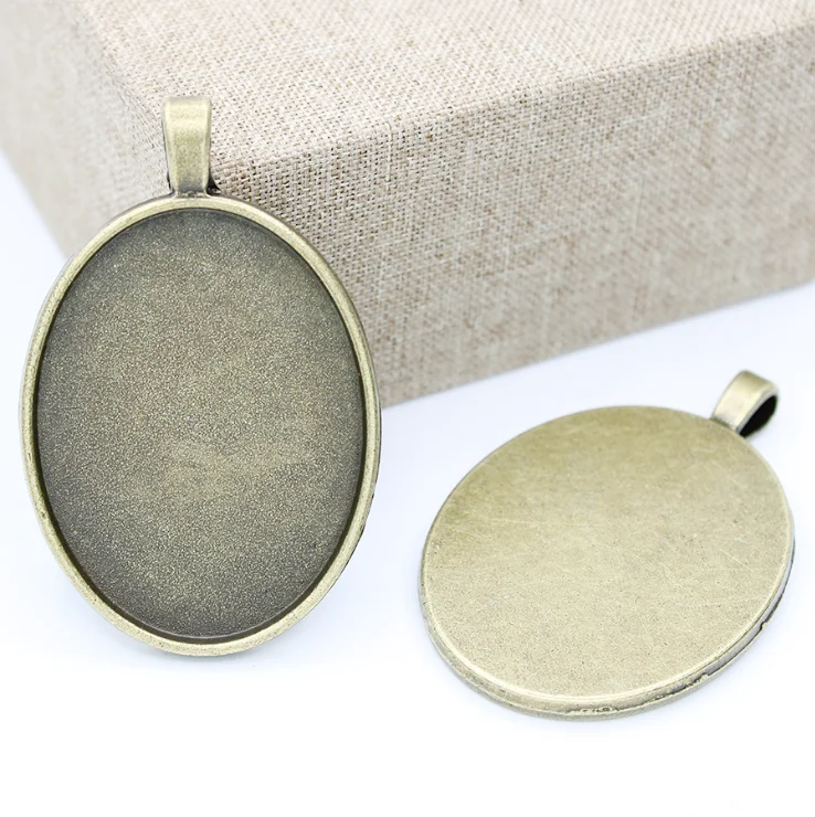 

2022 Hot Selling Wholesale Antique Bronze Silver Tone Oval Blank Tray Ornament Disk Pendant Blank, Picture