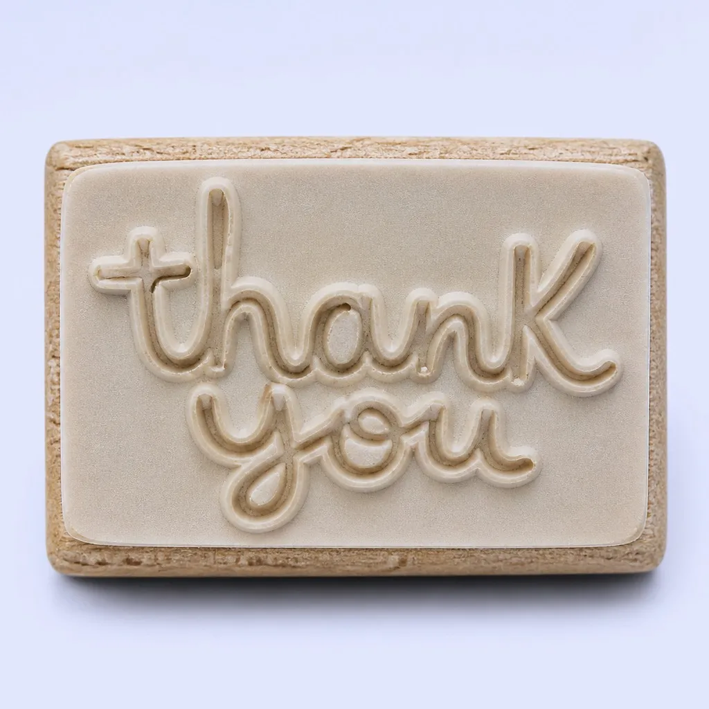 Close-up of an English word engraved on a rubber stamp base