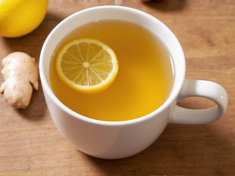 Golden homemade ginger tea in ceramic mug with lemon slice