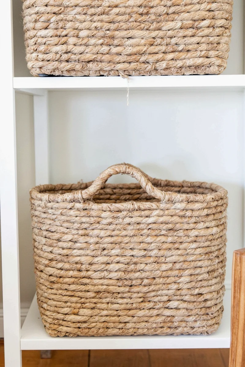 Baskets used creatively to hide cords around a TV stand