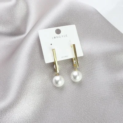 

A pair of pearl earrings with geometric metallic feel stylish accessories
