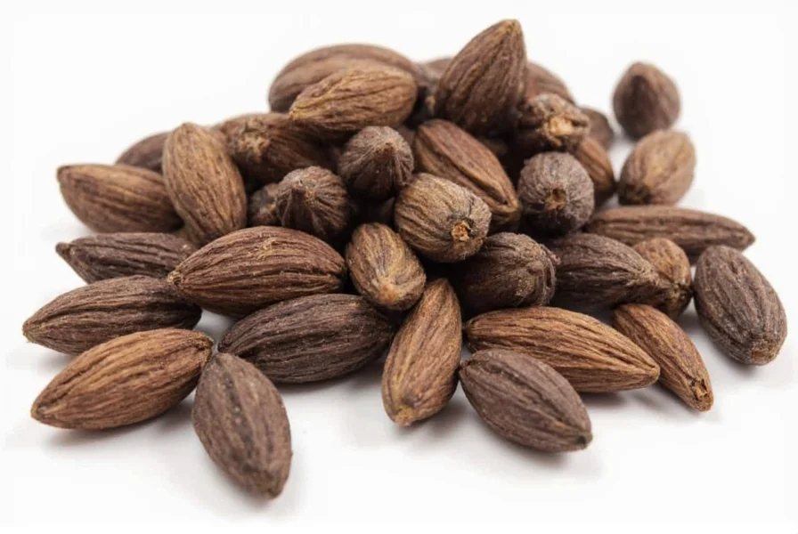 Close-up photograph of black cardamom pods showing their dark, rough texture compared to smooth green cardamom pods