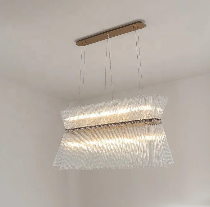 Rose gold fixture clear glass bars chandelier lamp over kitchen table