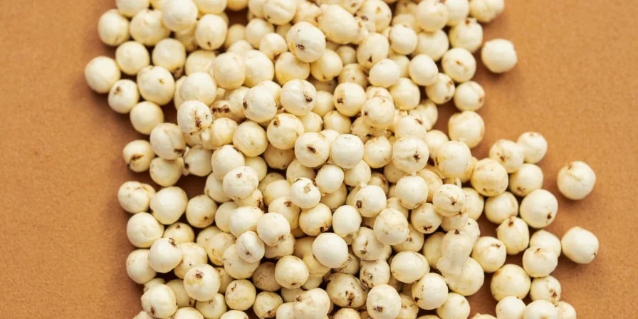Chef Sprinkling White Pepper into a Soup Pot