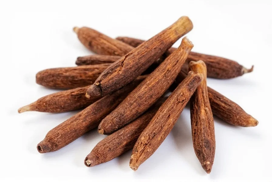 Allspice berries next to ground cloves for substitution comparison