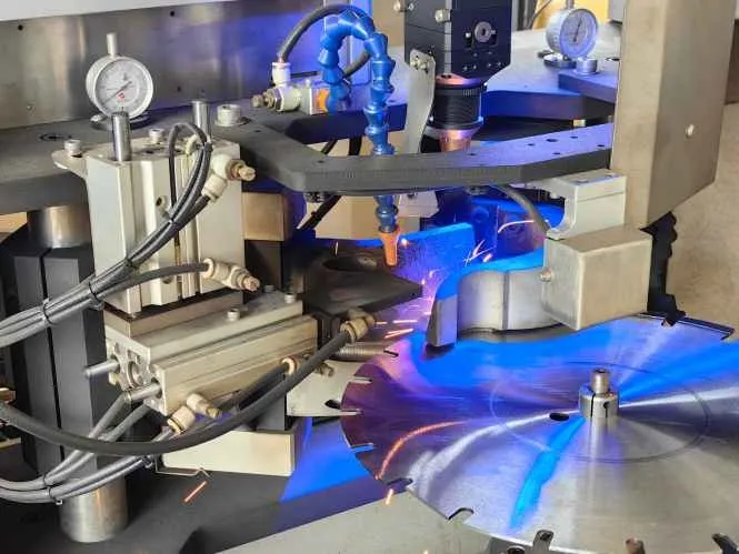 Close-up of saw blade welding equipment in operation