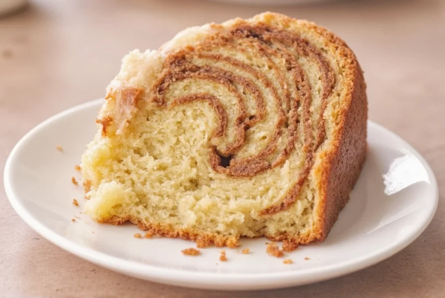 Close-up of cinnamon swirl cake cross-section showing perfect marbling pattern