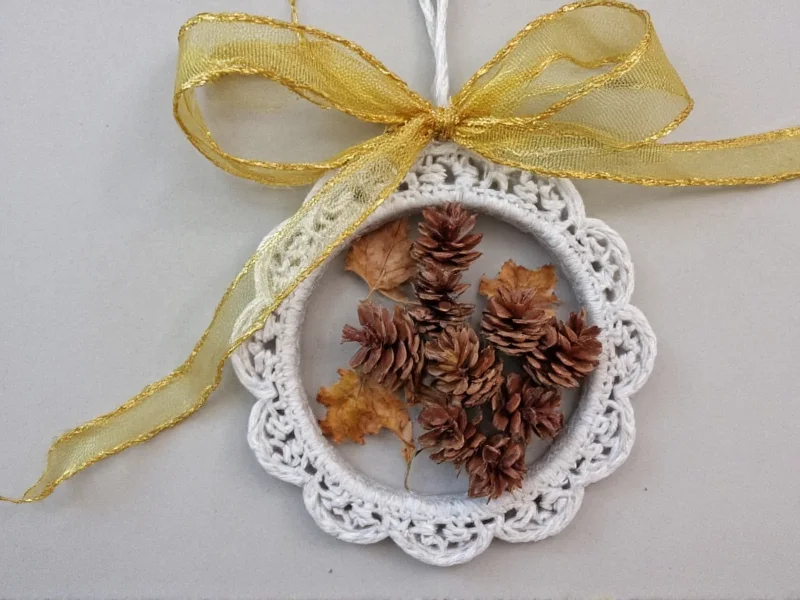 Handmade ornament using pinecones and dried leaves