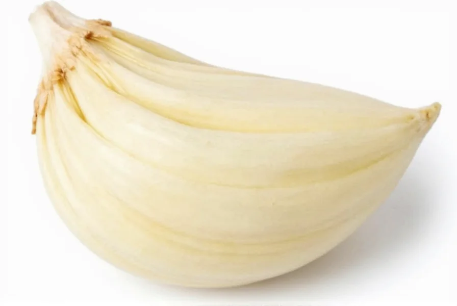 Chef's hand measuring minced garlic into a tablespoon for recipe preparation
