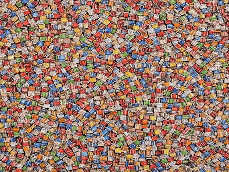 Colorful woven magazine strips forming geometric wall art