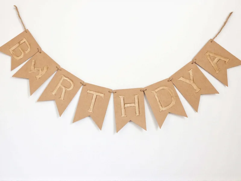 DIY birthday banner made from recycled kraft paper and twine