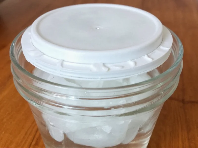 DIY distilled water setup with inverted lid and ice