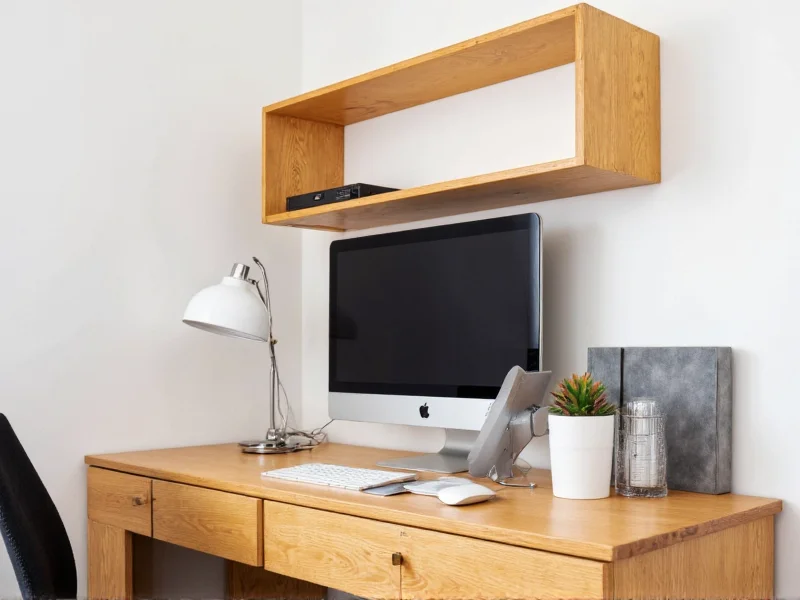 Wall-mounted wooden crate desk in compact apartment workspace
