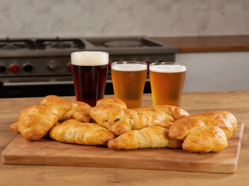 Homemade kolaches with craft beer flight on kitchen counter
