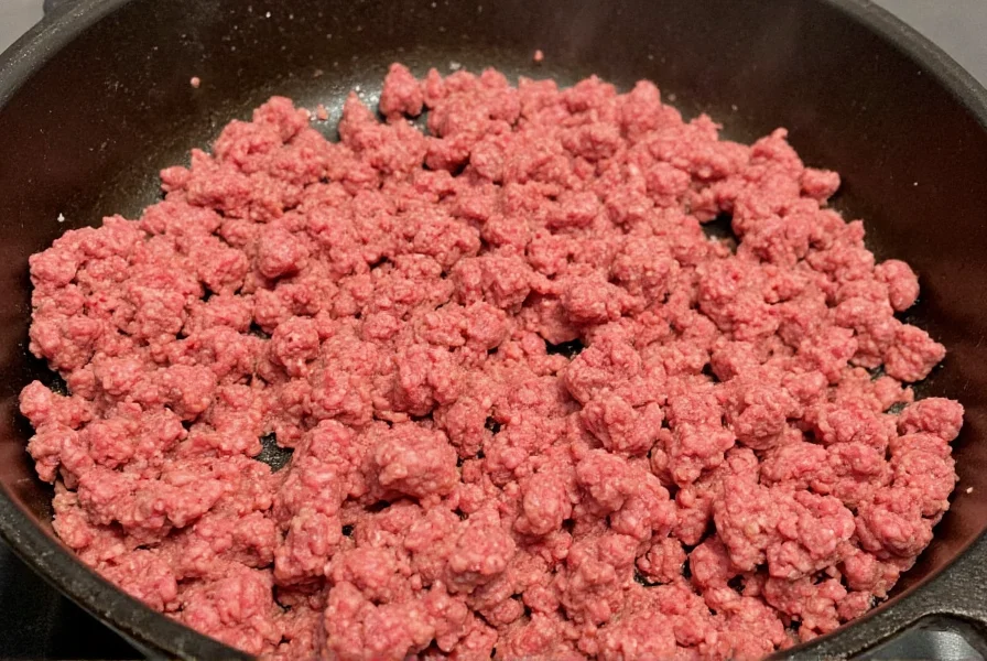 Perfectly browned ground beef in cast iron skillet for chili preparation