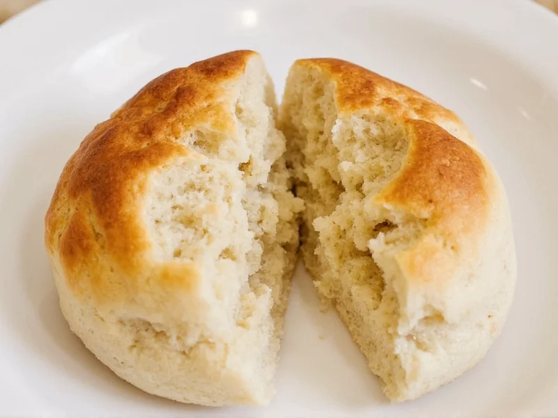Split homemade english muffin showing nooks and crannies