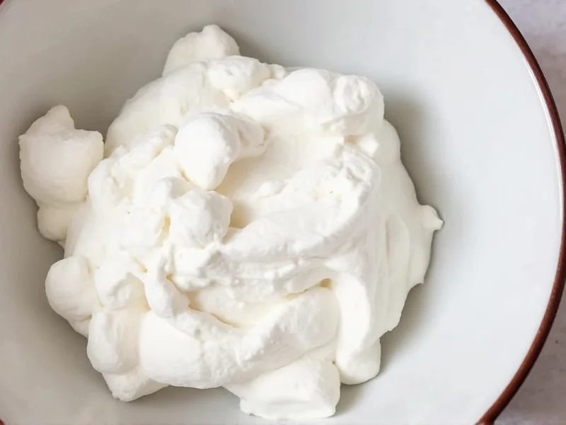 Homemade marshmallow fluff showing soft peak stage in bowl