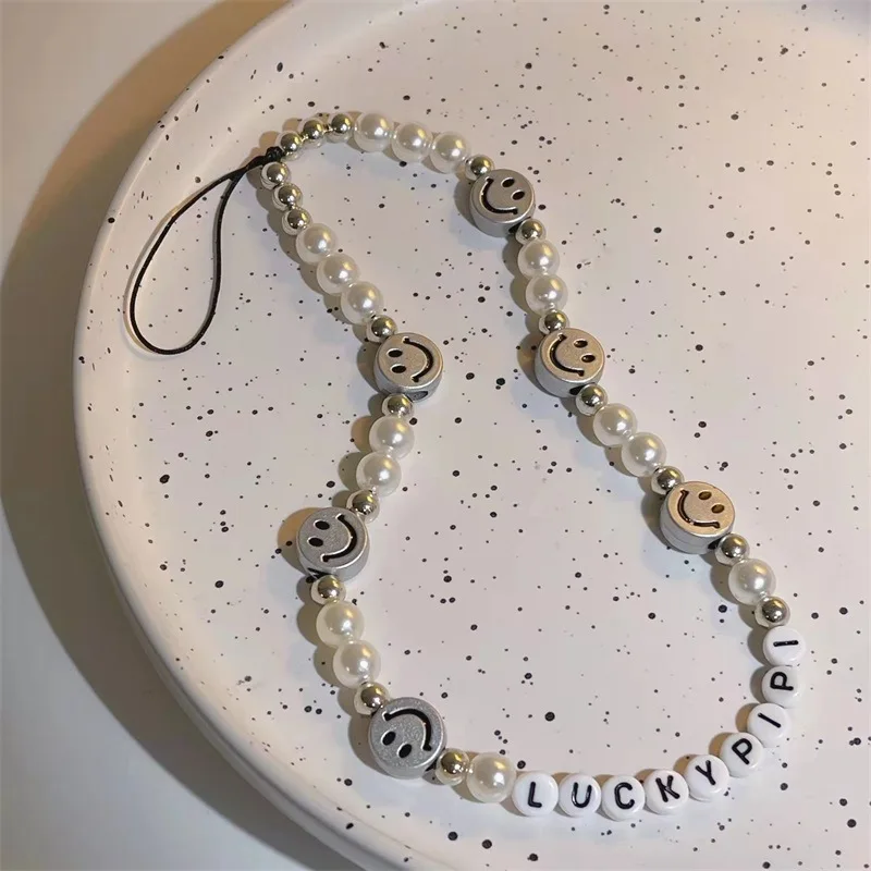 

Original Design Classic Black White Bead Phone Chain INS Metal Smile Luck Phone Wrist Strap 2021