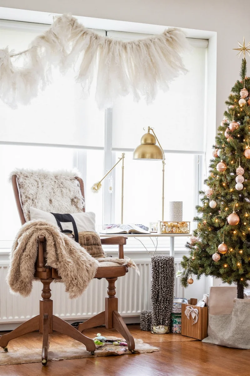 Festively decorated office desk with mini tree, candles, and ornaments