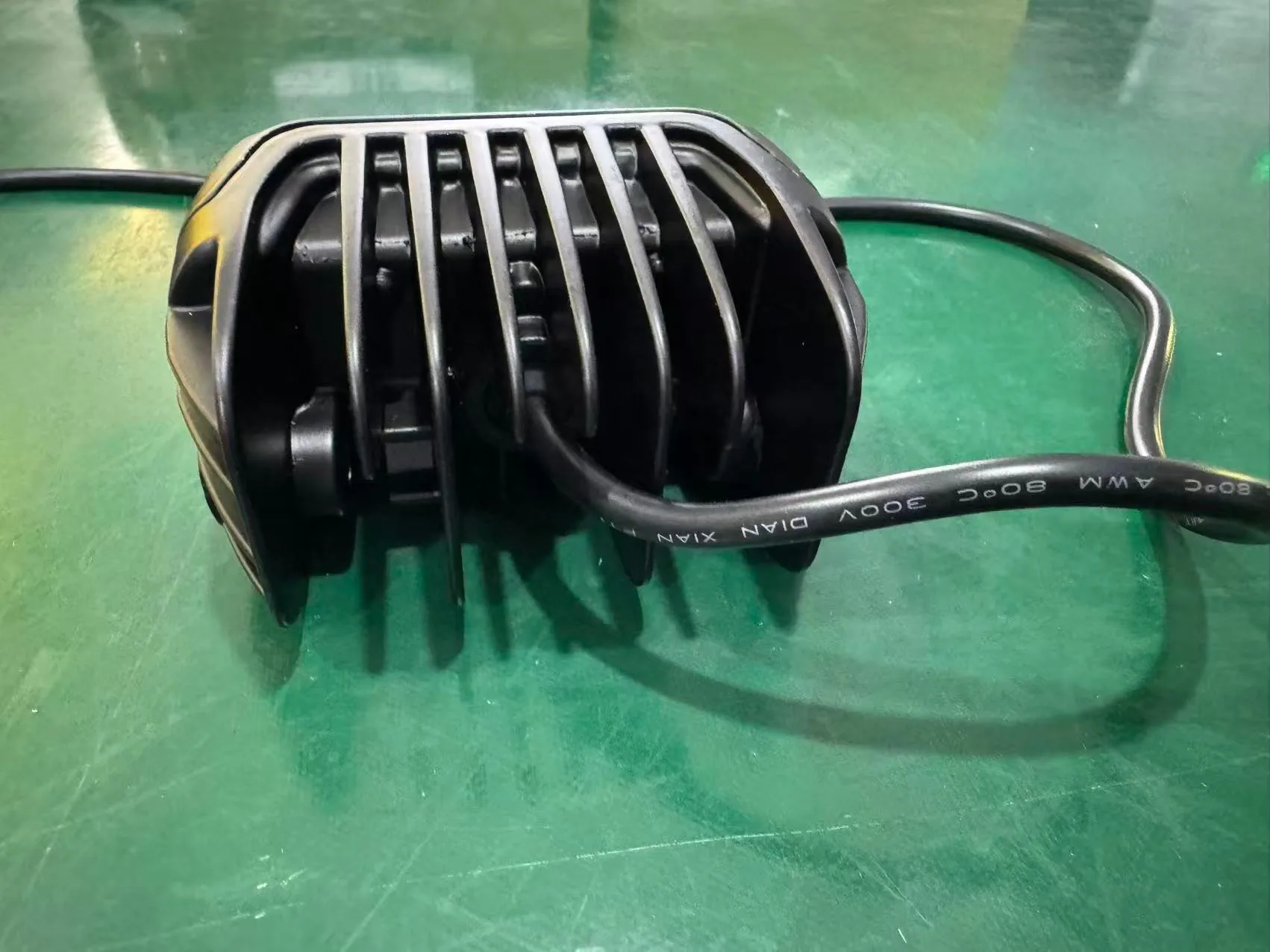 Die-cast aluminum motorcycle auxiliary light housing with heat-sink fins and cable
