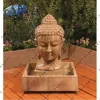 small buddha head carved water feature