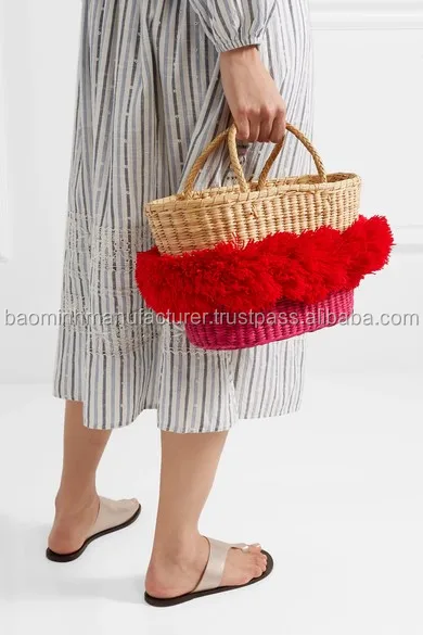 woven bag with pom poms