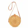 Fashionable rattan bag with long leather trap and round shape